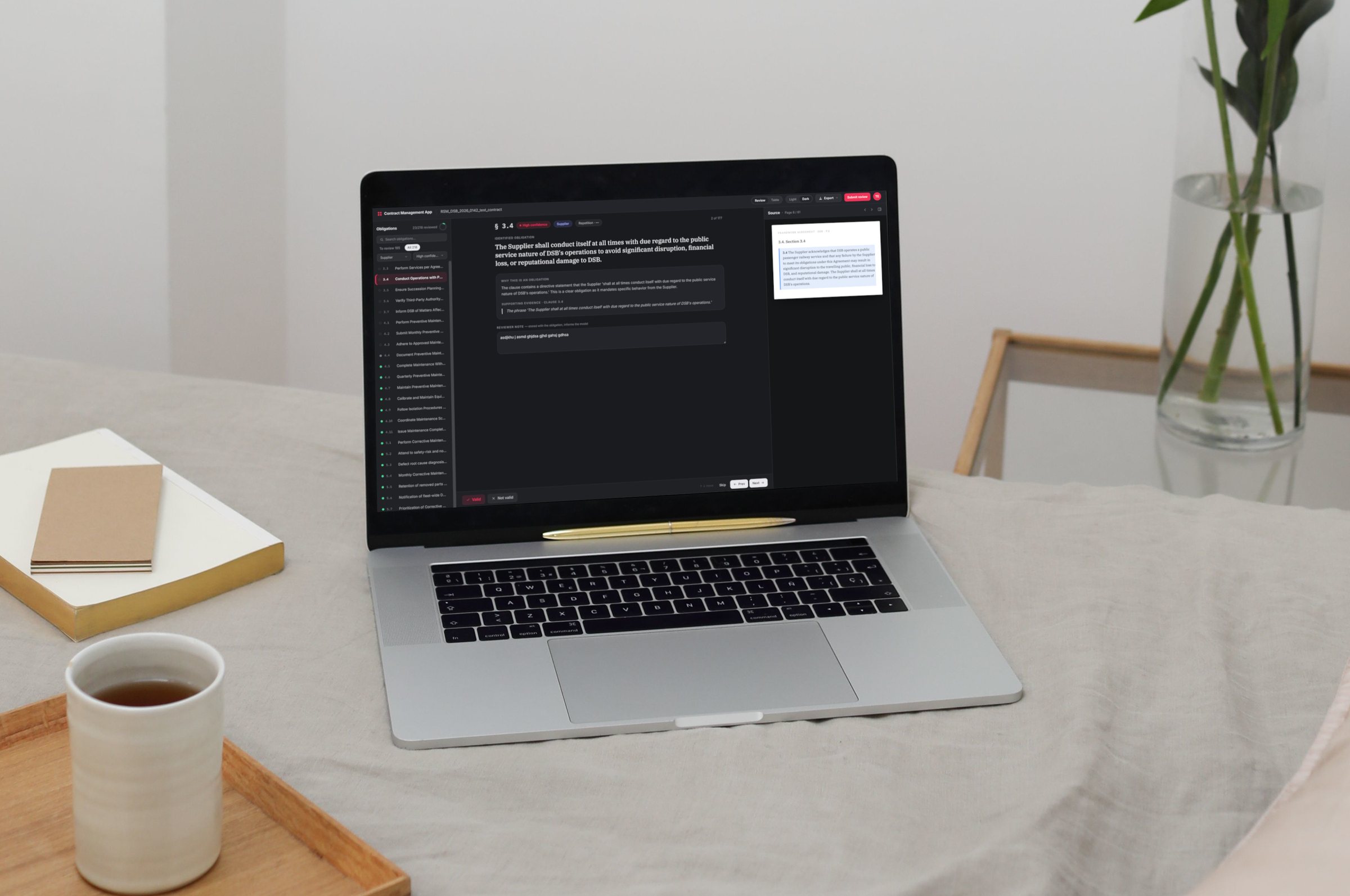 The production contract review application open on a laptop, showing the obligation queue, selected obligation with reasoning and the source contract clause